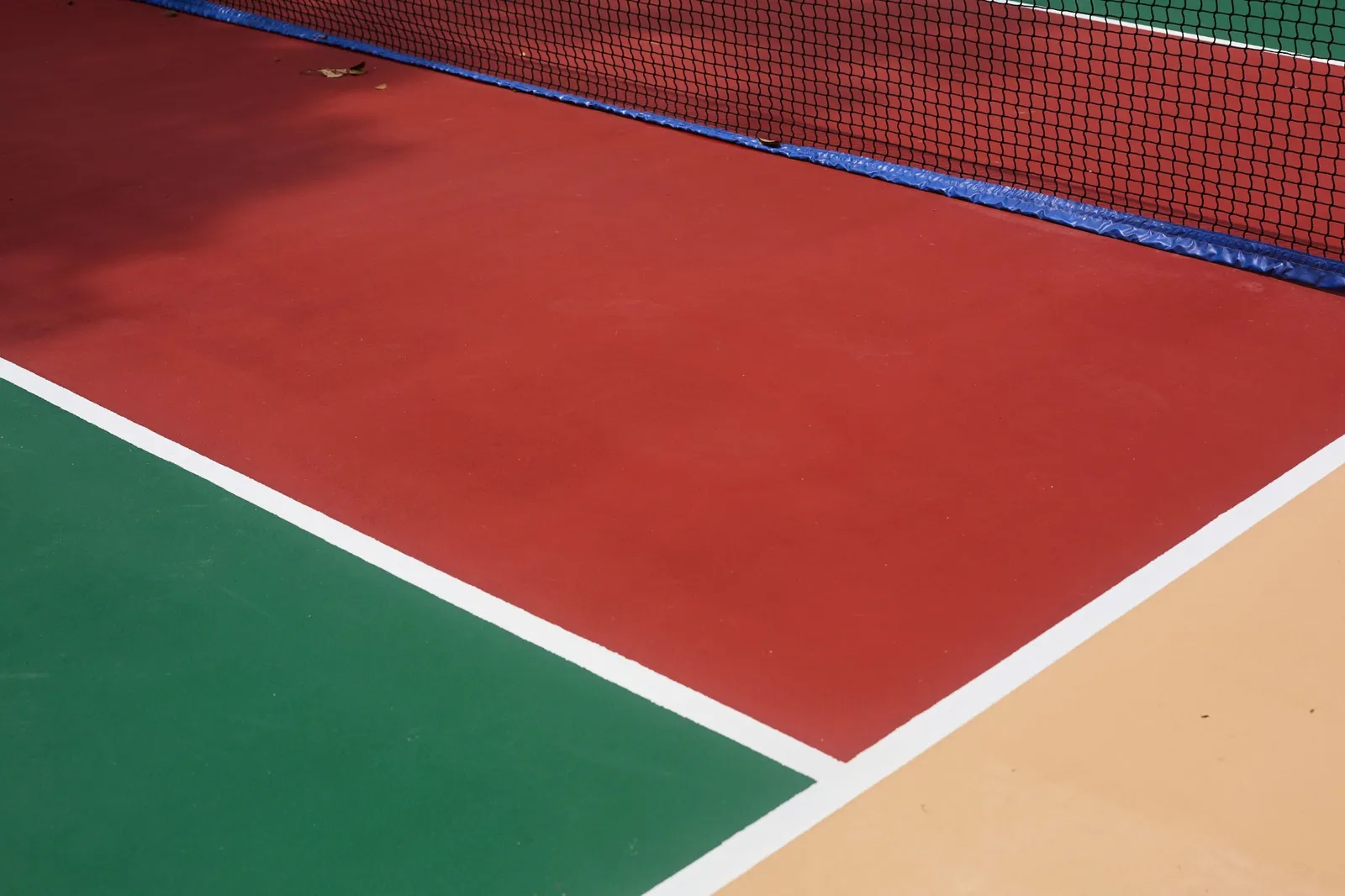 Close-up of the pickleball court surface and net